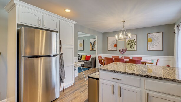 A modern kitchen with white cabinetry, a stainless steel refrigerator, and a granite countertop. - Family Retreat w/ Game Room, 4 Mi to Kalahari! (Long Pond)