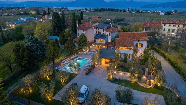 A large villa with a swimming pool, multiple guest rooms, and a view of the surrounding countryside. - Residenza Lugana Apartments (Peschiera del Garda)