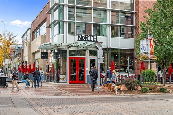A modern building with a prominent 'NORTH' sign, glass doors, and a covered entrance.