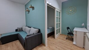 Ein kleines Zimmer mit einem Bett, einem Schreibtisch und einem Stuhl.