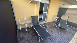 A small balcony with a metal table, two chairs, and a folding chair. - Appartamento Perugia 705/B (Perugia)
