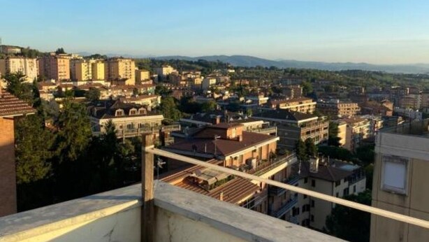 A cityscape with a variety of buildings, including residential and possibly commercial structures. - Appartamento Perugia 705/B (Perugia)