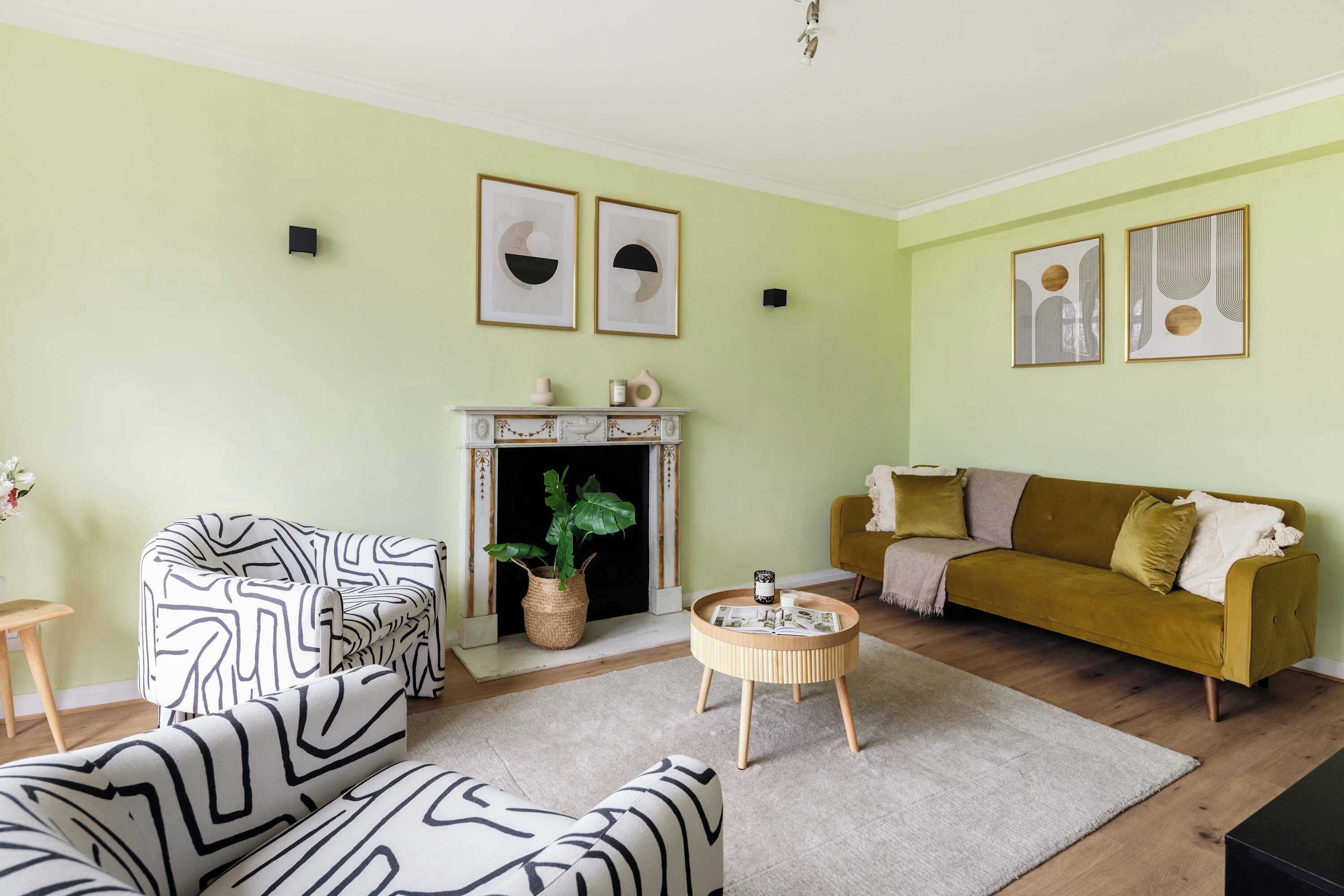 A living room with a sofa, a round coffee table, a fireplace, and a couch.