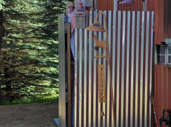 A corrugated metal gate with a 'WELCOME' sign, a bell, and a horse figure. - NEW! Little Ranch Therapy - Hot Tub, Fireplace (Traverse City)