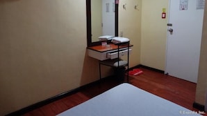 A small hotel room with a single bed, a bedside table, a mirror, and a wardrobe. - Hotel Sogo Cartimar Recto (Manila)
