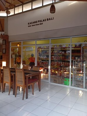 A restaurant named "KACANG PULAU BALI" with a tiled floor and wooden chairs. - Mansu Hotel & Spa (Denpasar)