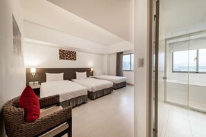 A hotel room with two beds, a large window, and a view of the sea. - Mola Mola Four Seasons Hotel (Hualien City)