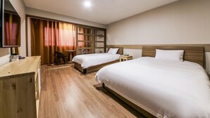 A hotel room with two beds, a desk, a TV, and a sliding door with curtains. - Huesik Hotel Sydney (Jeju City)