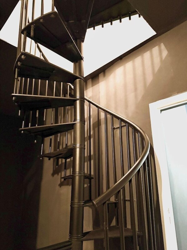 A spiral staircase with metal railings and a skylight above. - Music Hotel (Marseille)