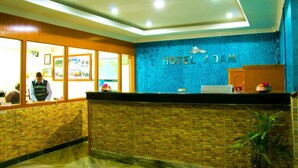 A reception area with a blue wall and a reception desk. - Hotel Adam (Pokhara)