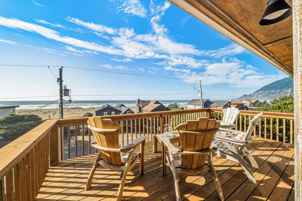 A wooden deck with Adirondack chairs overlooking a beach and ocean. - Ocean Views, Dogs Ok, Steps to the Beach & Walk to Town!-Manzanita Magic (Manzanita)