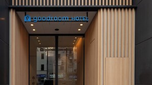 The exterior of a hotel with a modern design, featuring vertical wooden slats and a glass entrance. - goodroom hotel Kyoto (Kyoto)