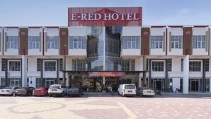 A hotel with a prominent sign reading 'E-RED HOTEL' and a banner stating 'PEMBUKAN RASMI GRAND OPENING'. - E Red Hotel Cosmo (Bukit Mertajam)