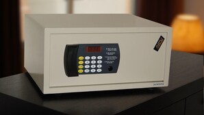A white safe with a digital keypad, a red display, and a small logo on the right side. - E Red Hotel Cosmo (Bukit Mertajam)