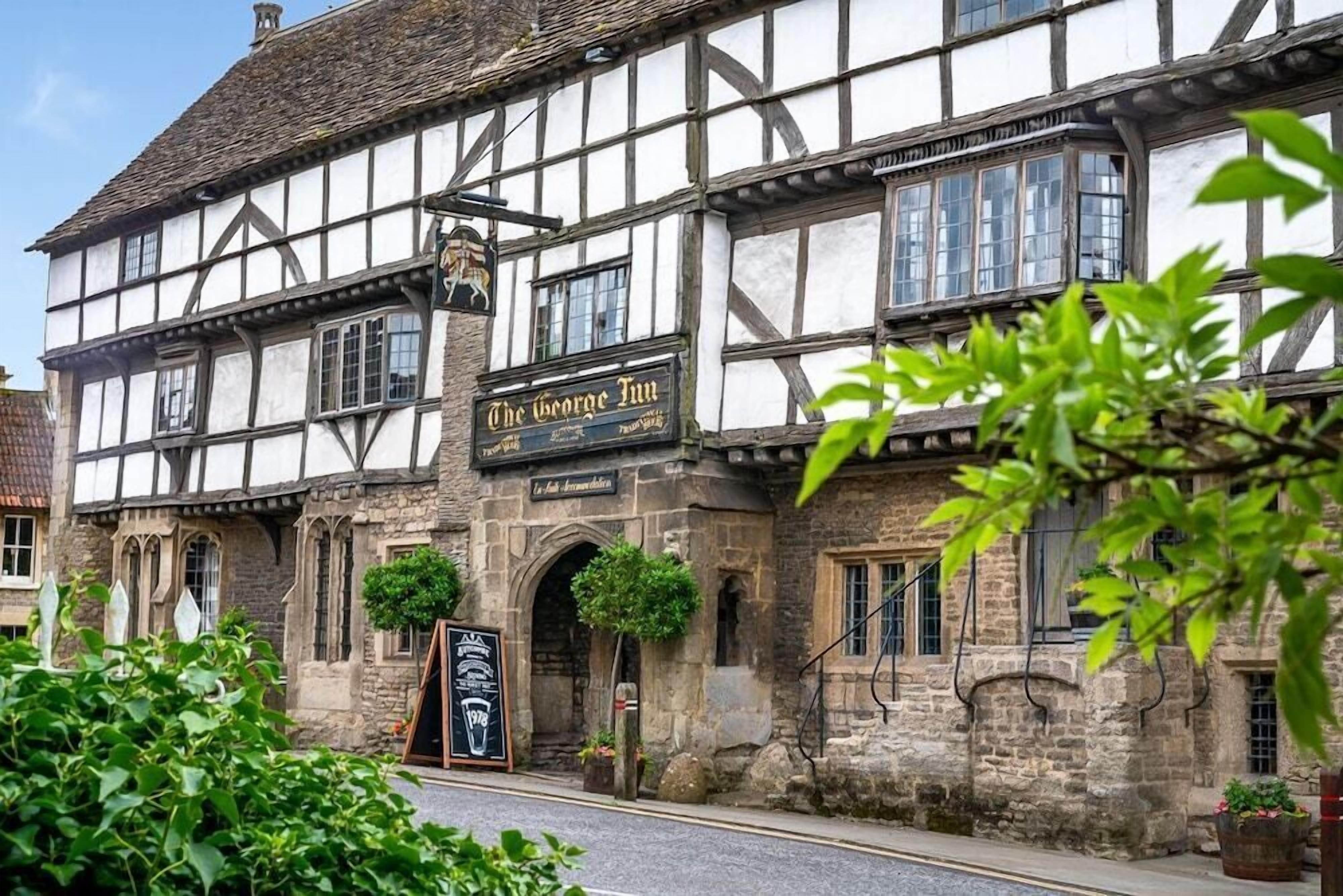 A traditional half-timbered building with a sign reading "The George Inn".