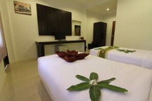 A hotel room with two beds, a television, and a desk. - Khanom Maroc Resort and Spa (Khanom)