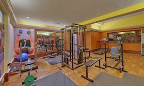 A gym with various exercise equipment, including a squat rack, benches, and a treadmill. - The Fern Kesarval Hotel & Spa Verna Plateau, Goa (Verna)