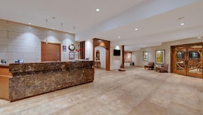 A hotel reception area with a marble counter, wooden accents, and a spacious layout. - The Fern Kesarval Hotel & Spa Verna Plateau, Goa (Verna)