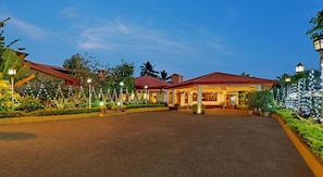 A hotel with a paved courtyard, a covered outdoor area, and string lights. - The Fern Kesarval Hotel & Spa Verna Plateau, Goa (Verna)