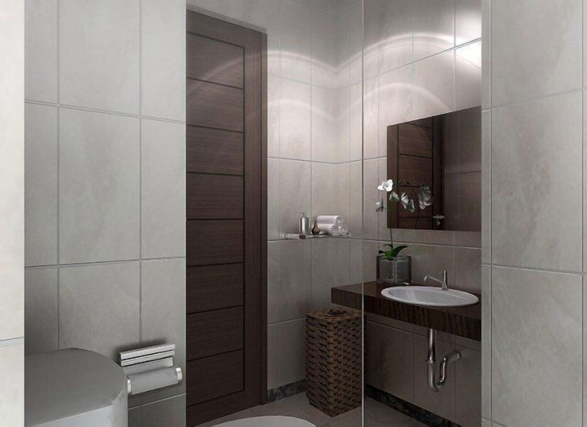 A modern bathroom with a large mirror, a sink, and a toilet.