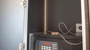 A safe deposit box with a keypad lock, a cable, and a coin slot. - Bunk Backpackers Surfers Paradise Hostel (Gold Coast)