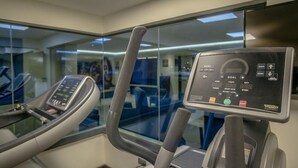 A stationary bike with a digital display and control panel. - The Landmark Suites (Nairobi)