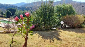 A garden with a pool, trees, and mountains in the background. - DREAM HOUSE at Douro Valley with river view at 30Kms of Porto (PENAFIEL)