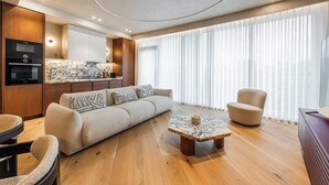 Uma sala de estar moderna com sofá, poltrona e mesa de centro.