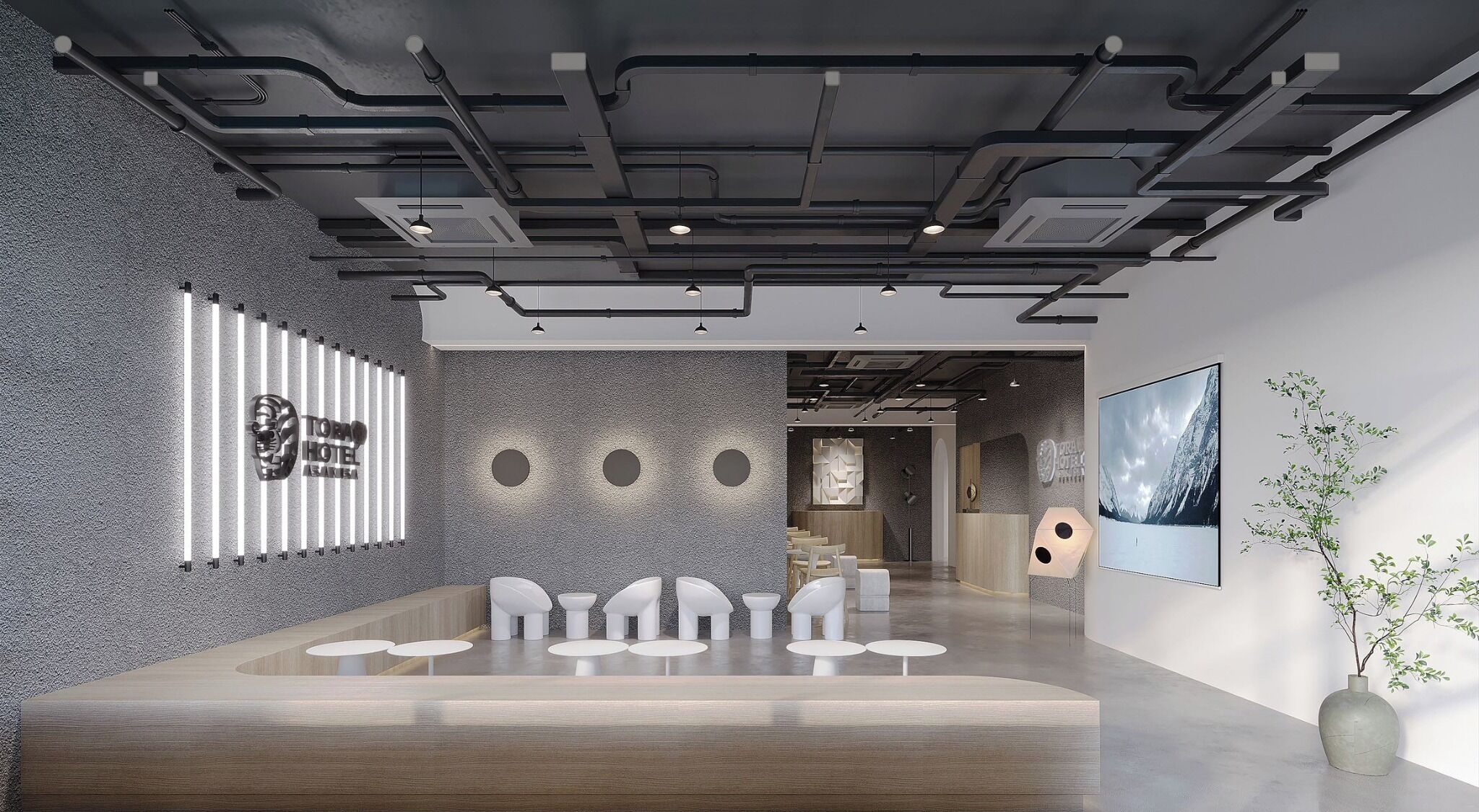 A modern hotel lobby with a reception desk, seating area, and a large framed picture on the wall.
