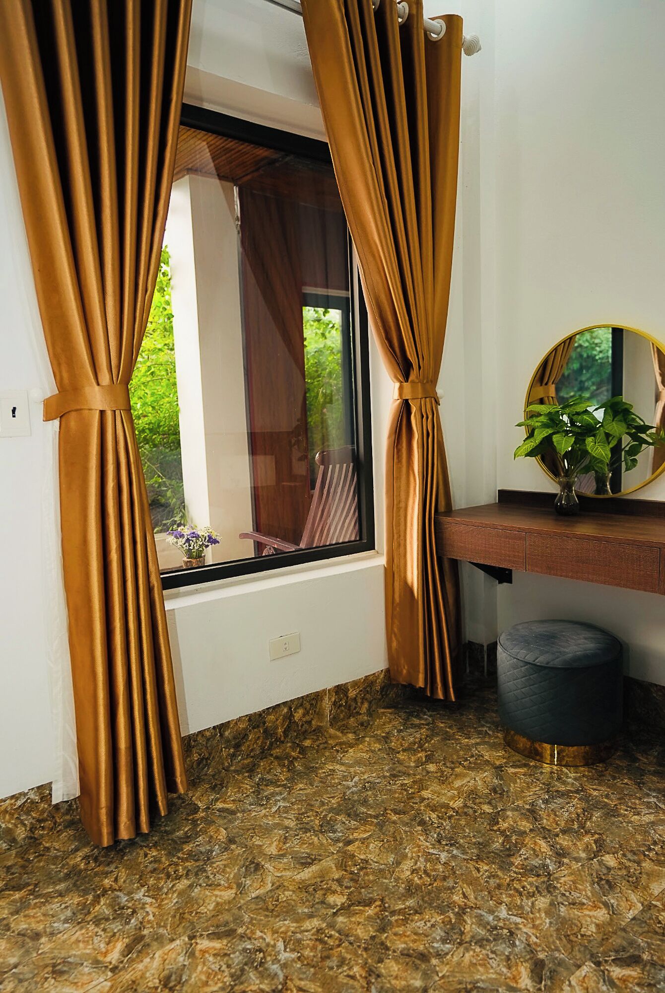 A bathroom with a window, a mirror, a sink, and a toilet.