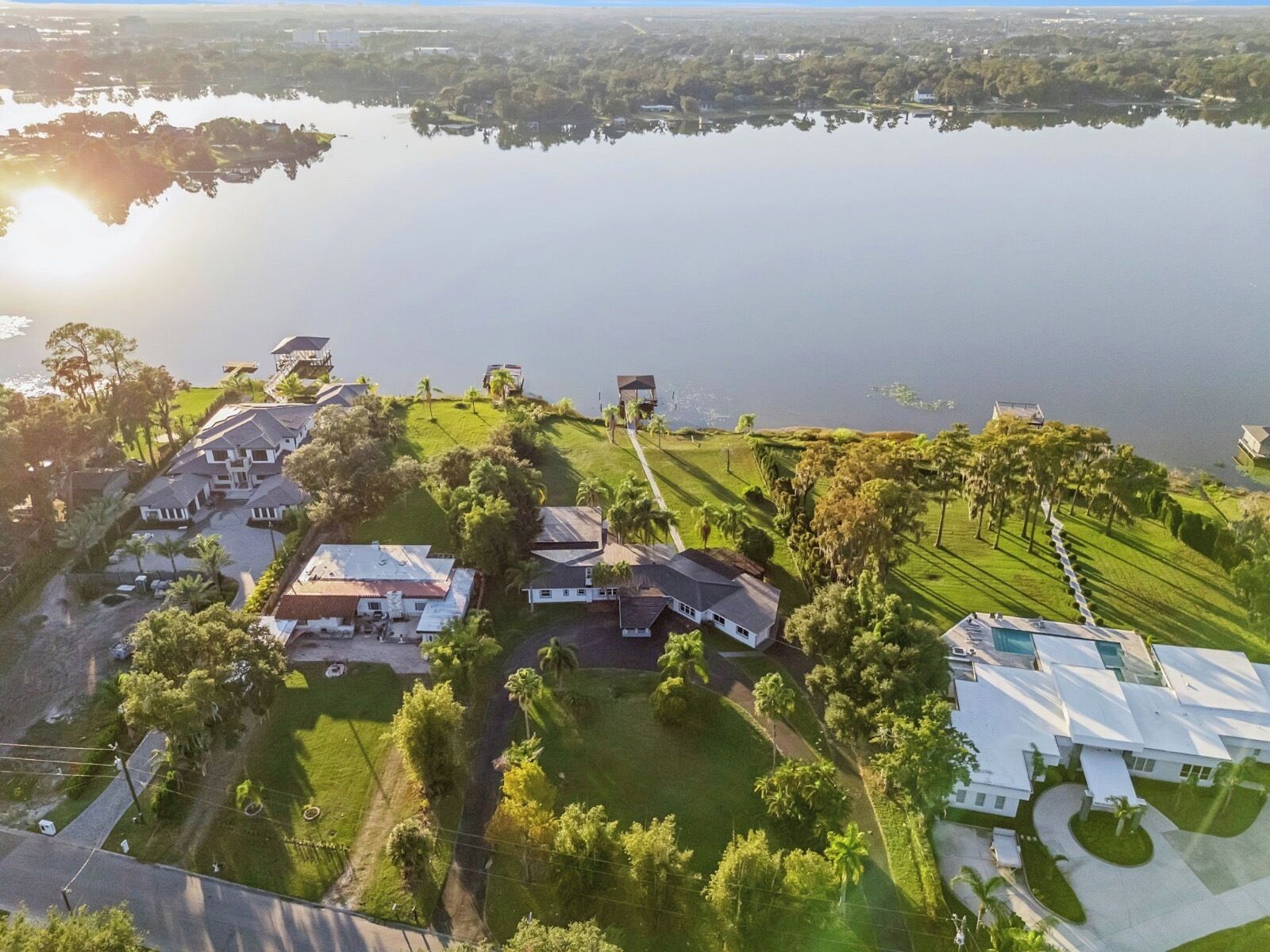 A residential area with houses and a large body of water.