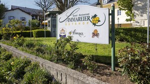 A sign for Hotel Restaurant Ammareier Gutshof with logos of Graf Arco, Albin Bach, and Weinstubn. - Grosszugiges Studio in Bad Birnbach (Bad Birnbach)