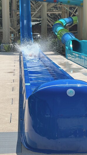 A water slide with a blue water channel and a blue slide at the bottom. - RV Lot w/ Private Dock Near Westgate River Ranch (Lake Wales)