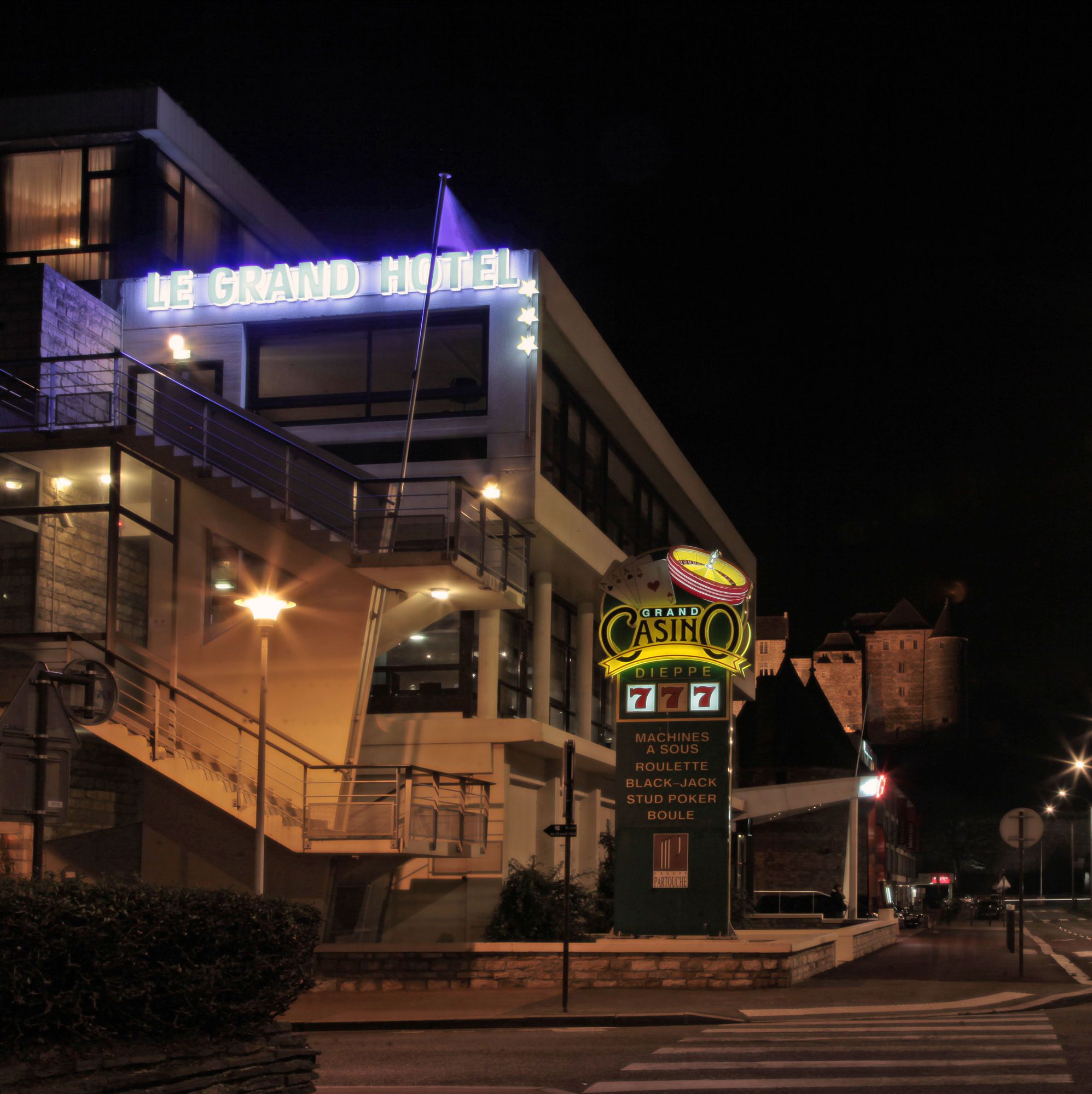 A building with a sign for 'Le Grand Hotel' and 'Grand Casino'.