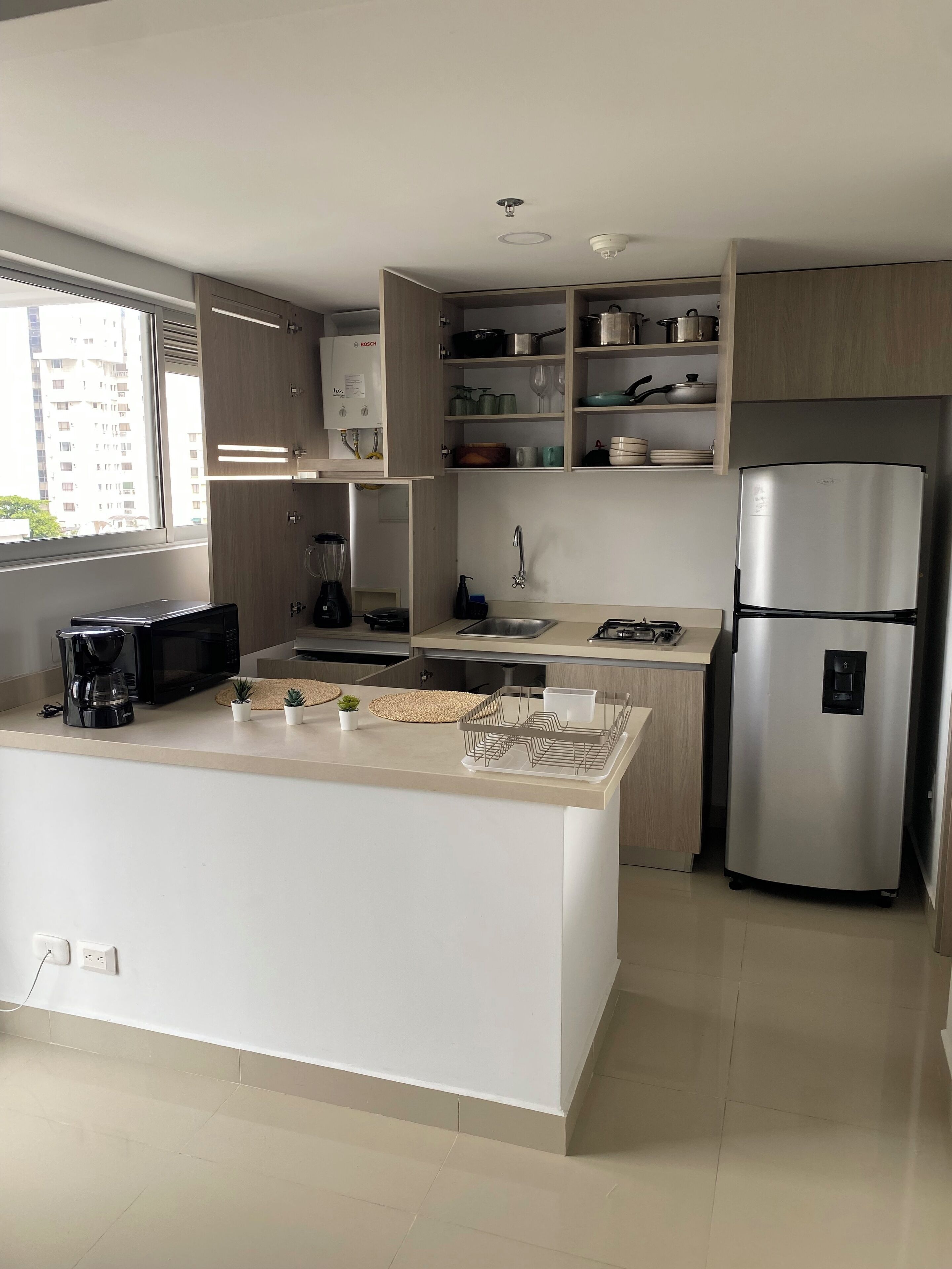 A modern kitchen with a central island, built-in appliances, and ample storage space.