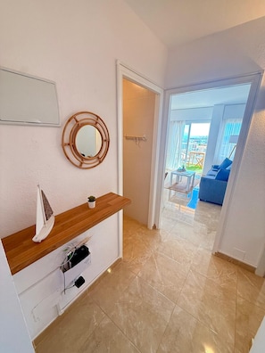 A modern bathroom with a wooden vanity, a round mirror, and a small potted plant. - BONANZA 1 SUNNY BEDROOM APARTMENT, NEW 2026! (Arroyo de la Miel)