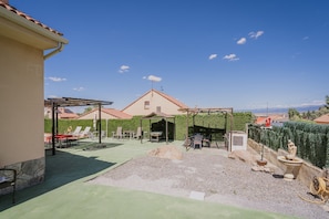 A patio with outdoor furniture, a pergola, and a view of the sea.