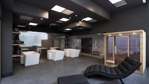 A modern interior with a black lounge chair, white sofas, and a glass door leading to a room. - Brickell Bay 3505 (Miami)