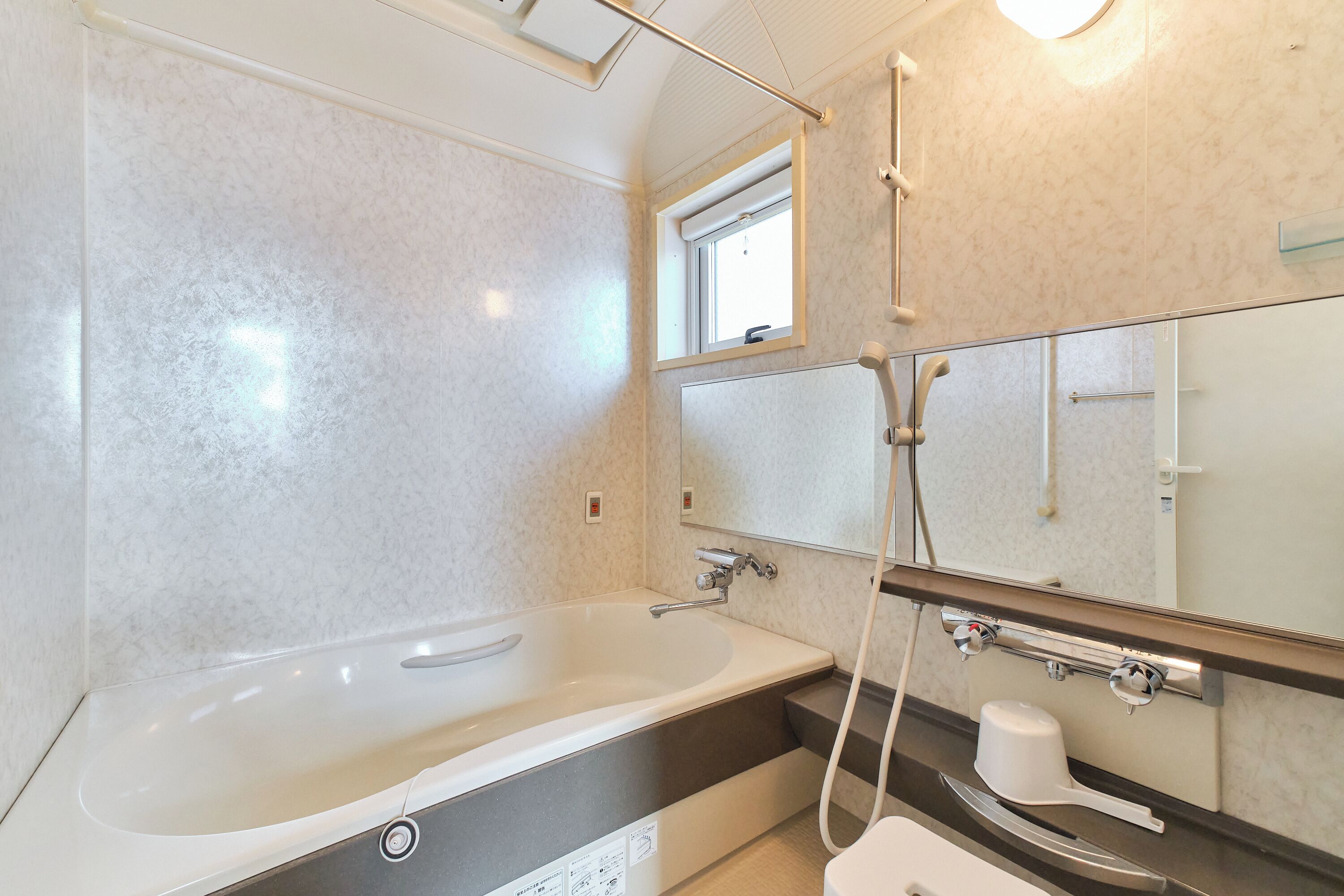 Ein modernes Badezimmer mit einer großzügigen Badewanne, einer Duschkabine und einem Waschtisch mit Spiegel.