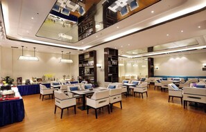 A spacious hotel lobby with multiple seating areas, a reception desk, and a large mirror reflecting the interior. - Ramada Encore by Wyndham Wuhan (Wuhan)