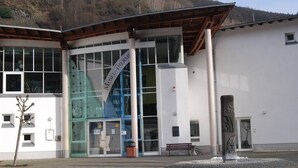A modern building with large glass windows, a prominent sign reading "MUSEUM," and a stone sculpture in front. - Spacious room, private retro bathroom spring water (Traben-Trarbach)