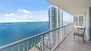 A balcony with a view of the ocean and high-rise buildings. - The Club Luxury Condos by Ilios Rentals (Miami)