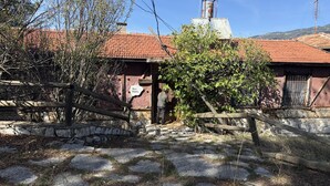 A rustic building with a stone wall entrance, a wooden gate, and a sign indicating a museum. - Ali Paşa Konağı (Akseki)