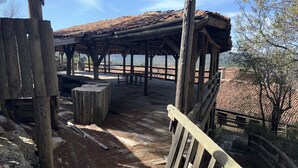 A rustic wooden gazebo with a tiled roof, surrounded by a wooden fence and overlooking a scenic landscape. - Ali Paşa Konağı (Akseki)