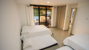 A hotel room with two beds, a sliding glass door leading to a balcony with a pool, and a sliding door to a private area. - Modern country house in Sopetran, Antioquia. (Antioquia)
