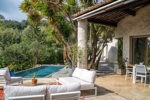 Ein Poolbereich mit Pool, Liegestühlen und einer Pergola.