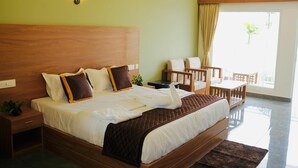 Una habitación de hotel con una cama de madera, una mesita de noche, un escritorio pequeño y una silla.