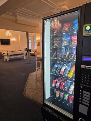 Ein Getränkeautomat mit Snacks, Wasser und Erfrischungsgetränken.