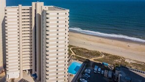 A high-rise hotel with a swimming pool and beach view. - Oceanfront 15th Floor Condo w/ Balcony & Pool (Ocean City)
