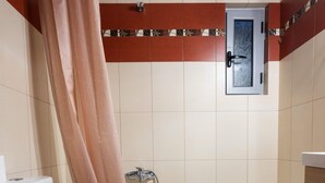 Une salle de bain avec des toilettes, un lavabo et une baignoire.